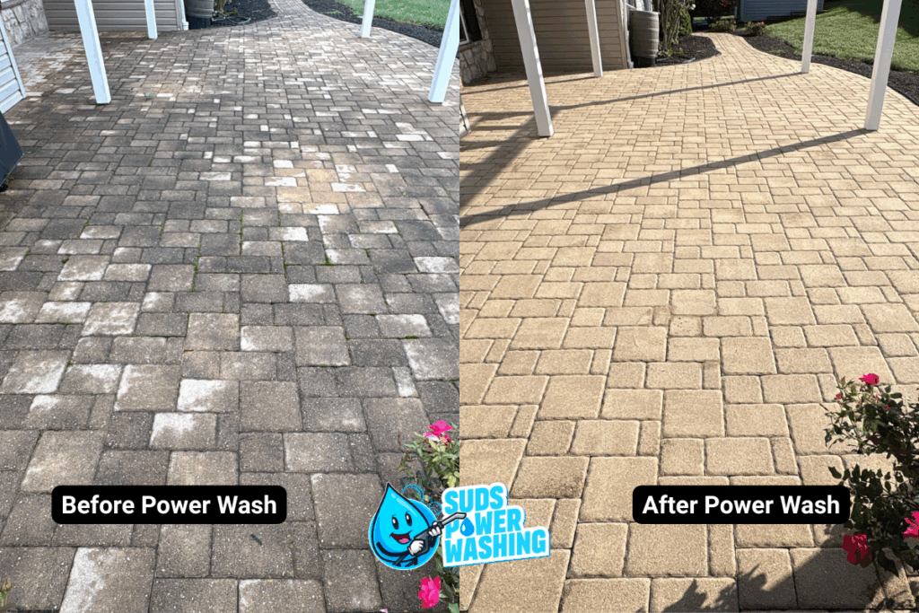 Side-by-side comparison of a paved patio: the left side is dirty and stained before power washing, while the right side is clean and bright after power washing. "Suds Power Washing" logo is at the bottom center.